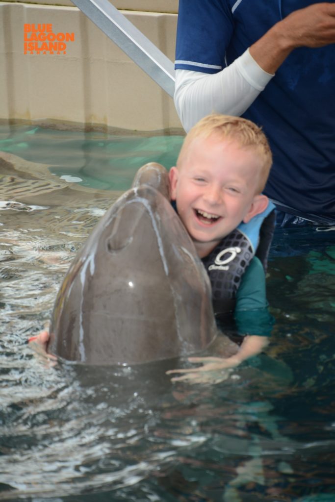 Landon Hartz with dolphin Cystinosis Research Foundation